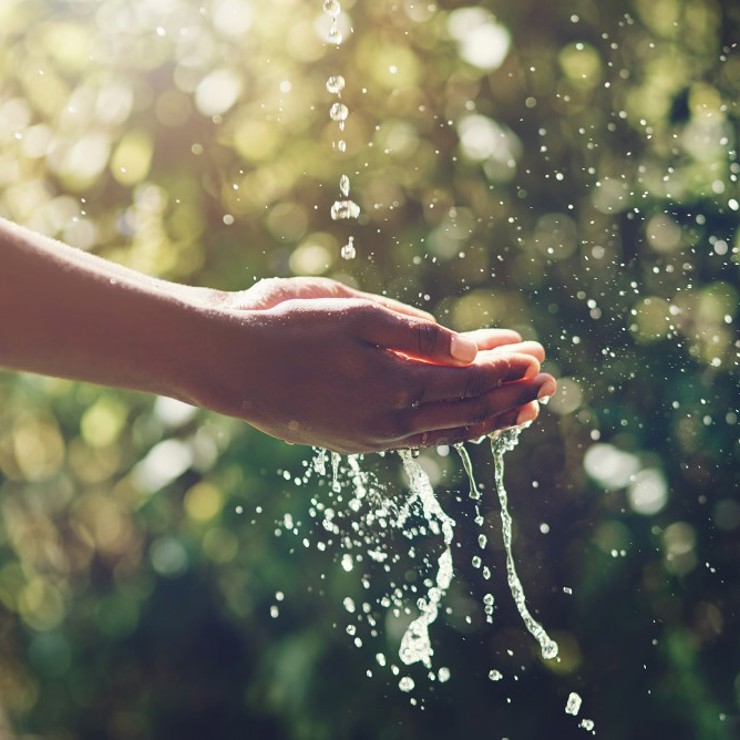 Hand Cupping Flowing Water