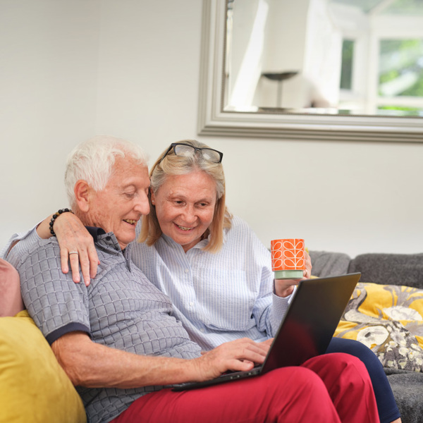 Grandparents Sitting On A Sofa