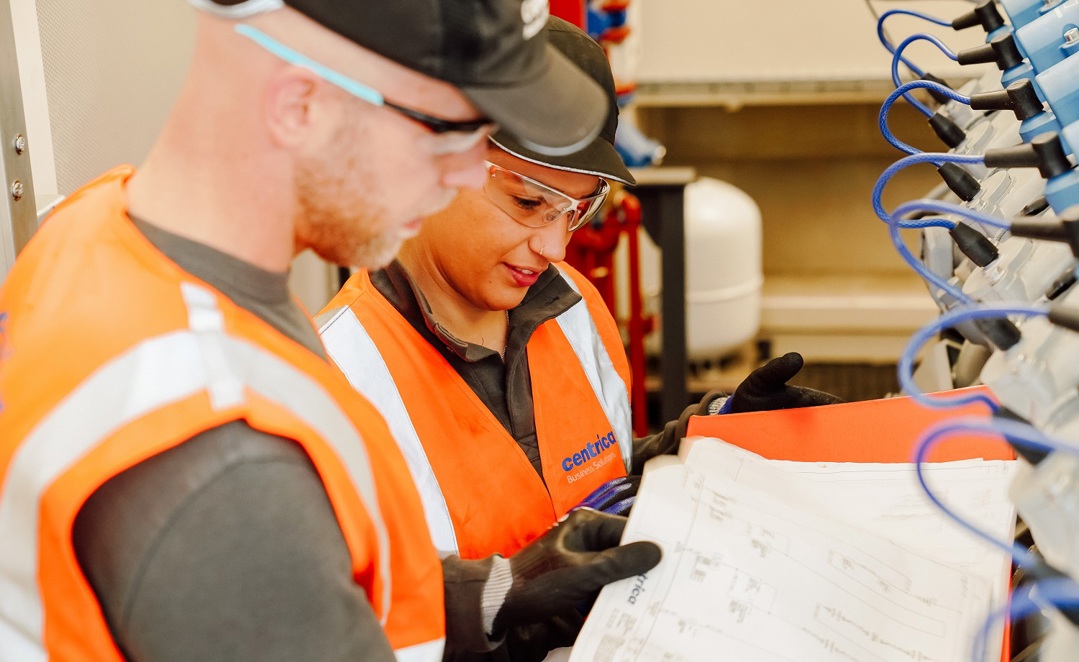 A female and a male Centrica Business Solutions engineer examine paperwork 