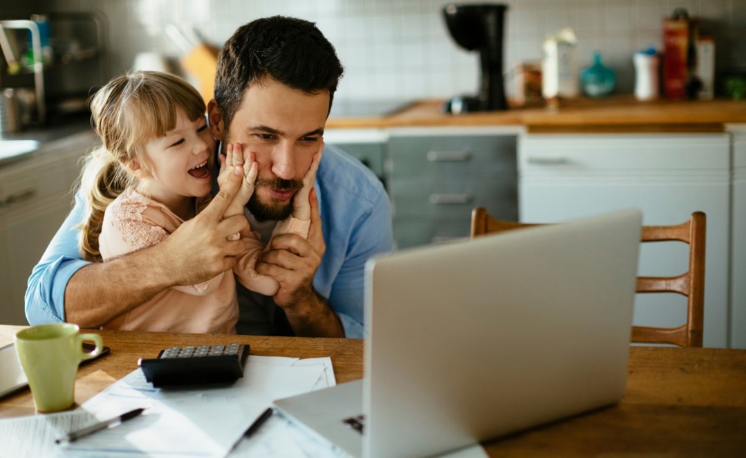 Father Working From Home With Daughter