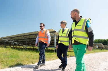 Bill Rees, director of Centrica Energy Assets, Chris Skidmore MP and Chris O'Shea the Centrica CEO walk in front of some solar panels at Codford Solar Farm